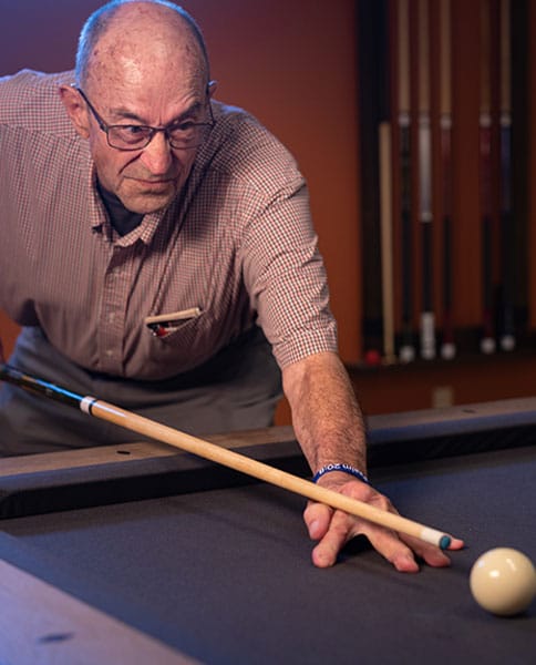 Senior man playing pool