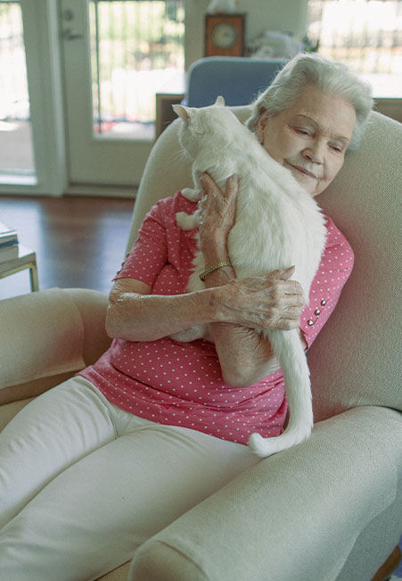Senior woman with cat in apartment