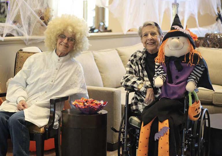 Residents dressed up waiting to hand candy to trick or treaters