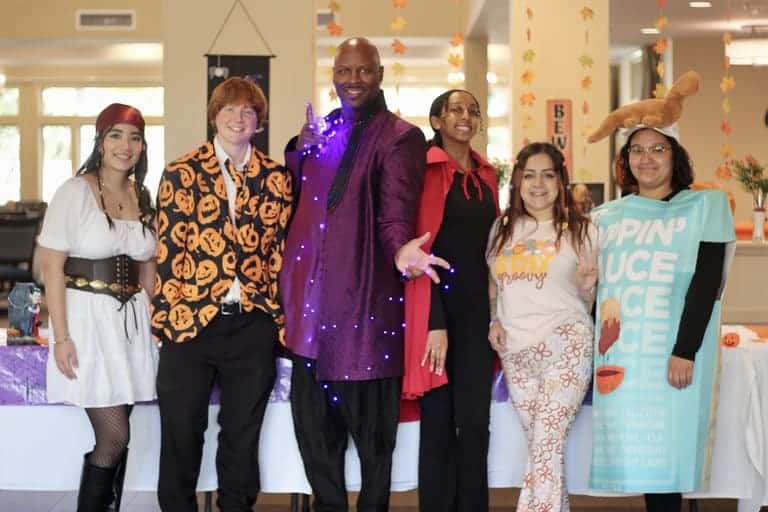 Residents dressed up waiting to hand candy to trick or treaters