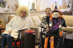 Residents dressed up waiting to hand candy to trick or treaters